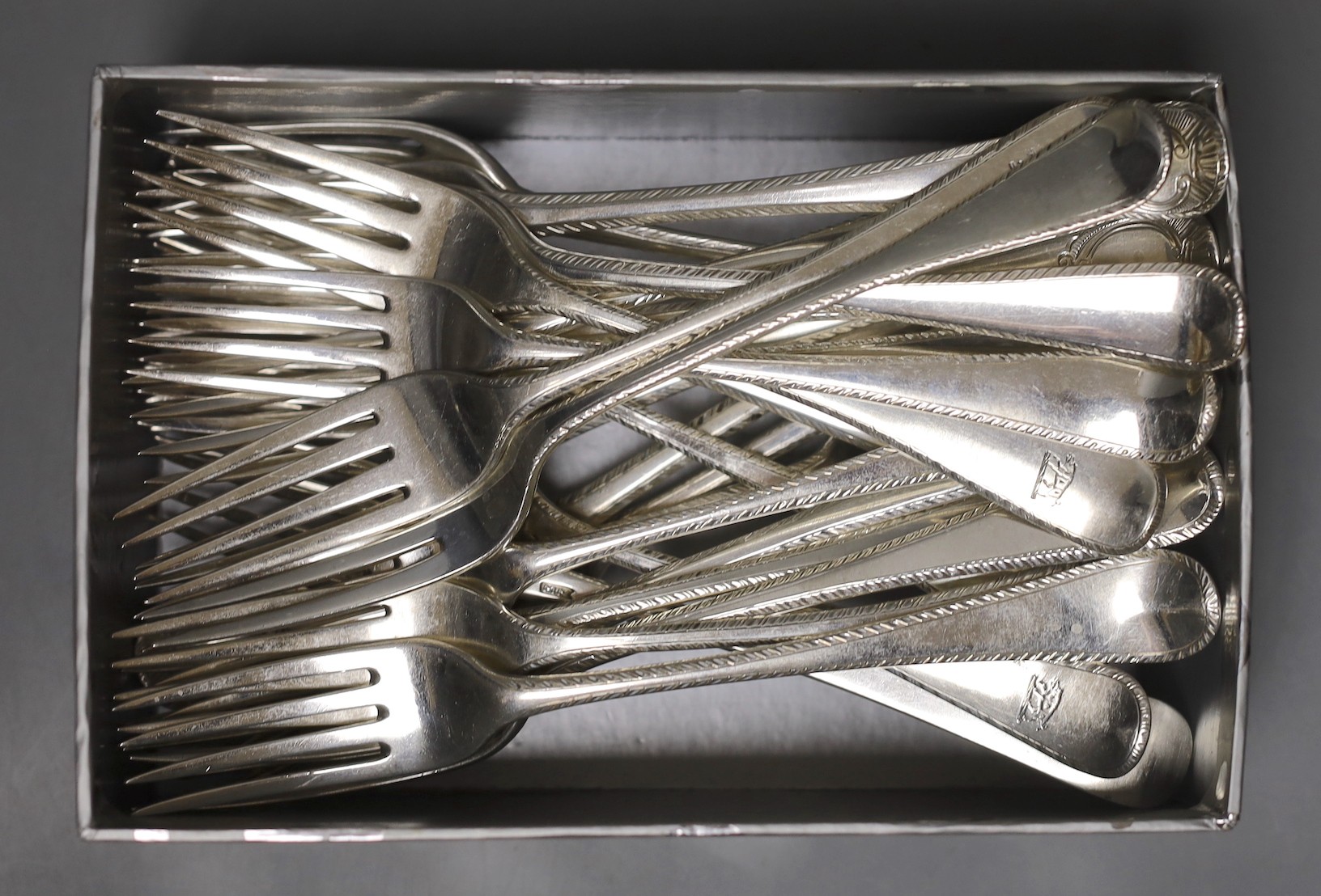 A matched harlequin set of twenty four late 18th/early 19th century silver Old English pattern feather edge table forks, various dates and makers, including eight Irish, by Michael Keating, Dublin, 1771/1773